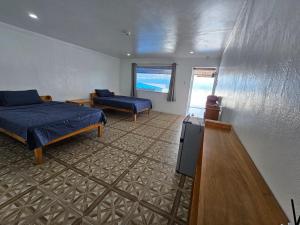 a bedroom with a bed and a couch in it at SARDINEBAY Dive Resort in Moalboal