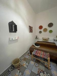 a bedroom with a bed and a bench in a room at Riad hotel borj in Tétouan +12 photos