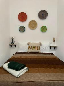 a bedroom with a bed with a family sign on the wall at Riad hotel borj in Tétouan