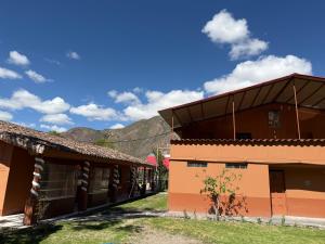 a building with a mountain in the background at La Quinta Eco Hotel in Urubamba