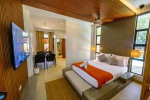 a bedroom with a bed and a tv in a room at Go Boutique Inn in Puerto Princesa City +93 photos