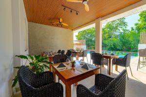 a restaurant with tables and chairs and a patio at Go Boutique Inn in Puerto Princesa City