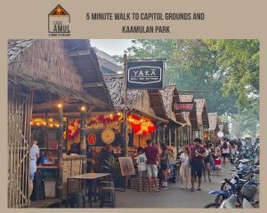 a crowd of people walking down a street in a market at Casa Amul in Tigbawan +2 photos