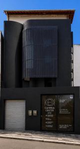 a black building with a sign on the side of it at Hotel Campina Center in Campina Grande +10 photos