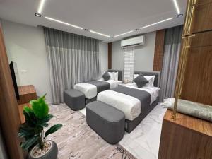 a hotel room with two beds and a couch at برج الهندي in Cairo