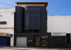 a black building on the side of a street at Hotel Campina Center in Campina Grande