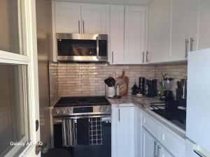 a kitchen with a stove and a microwave at Beautiful studio in Azusa +16 photos