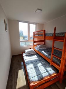 a bedroom with two bunk beds and a window at Casa Laguna Suites in Concepción