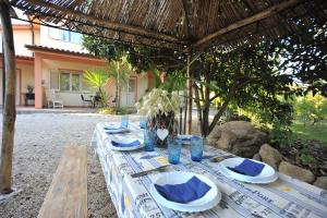 einen Tisch mit blauen Gläsern und Tafeln darauf in der Unterkunft Appartamenti Criage in Campo nell'Elba