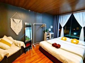 a bedroom with two beds and a large window at วันเดย์ภูทับเบิก in Ban Maeo Thap Boek