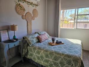 a bedroom with a bed and a table with a tray on it at Samambaias in Puerto Iguazú