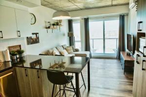 a living room with a table and a couch at Caïman - Le1006 in Quebec City