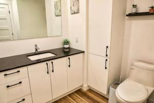 a white bathroom with a sink and a toilet at Caïman - Le1006 in Quebec City +27 photos