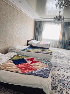 a group of three beds in a room at Adventure Guest House in Pokrovka
