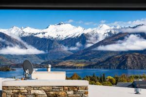 a view of a mountain range from a house at Alpine Vista with Mountain Views, Pool and Spa in Wanaka