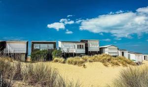 a group of houses on the beach near the sand at Les ridens in Sangatte