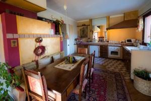 a kitchen with a wooden table and chairs at B&B Al Roncaccio in Calco