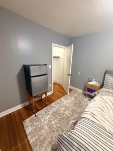 a bedroom with a bed and a tv in it at Grey comfort room in New London