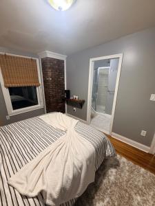 a bedroom with a large bed and a window at Grey comfort room in New London