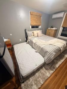 a bedroom with a large bed and a window at Grey comfort room in New London