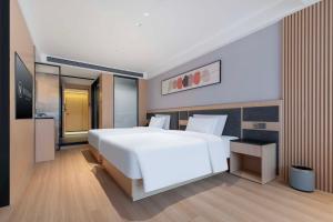 a bedroom with a large white bed in it at YIBON INTERNATIONAL HOTEL in Guiyang +47 photos