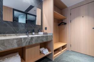 a bathroom with a sink and a mirror at YIBON INTERNATIONAL HOTEL in Guiyang