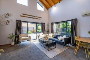 a living room with a couch and a table at Little Black Ski Chalet | Central, WiFi, Families! in Methven