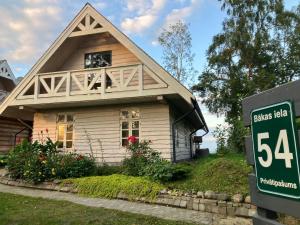 a house with a sale sign in front of it at First Line in Mērsrags