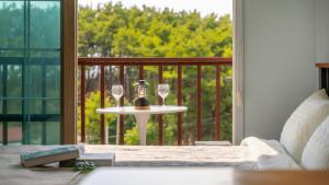 a table with two wine glasses on a balcony at Taean Atirans Beach Pension in Taean +2 photos