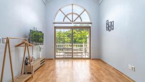 an empty room with a large window and a door at Taean Atirans Beach Pension in Taean