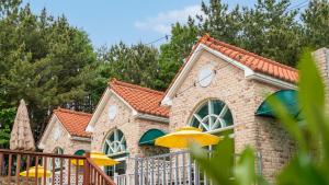 a building with yellow umbrellas in front of it at Taean Atirans Beach Pension in Taean