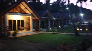 a house with a lawn in front of it at night at lala-Oh Resort in Lalao