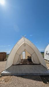 a tent is set up on the beach at Guest House of Issyk-Kul Camp in Chok-Tal