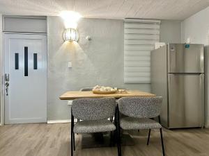 a kitchen with a table with chairs and a refrigerator at Gema del Mar, Vieques, PR in Vieques +29 photos
