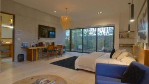 a large bedroom with a large bed and a kitchen at Cuna del Cielo in San Miguel de Allende