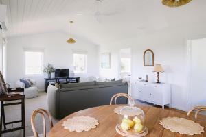 a living room with a table and a couch at Suma Park Estate in Point Lonsdale +16 photos