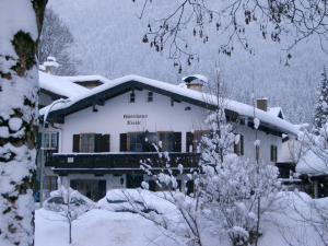 a house covered in snow with snow at Gästehaus Nicole in Garmisch-Partenkirchen +17 photos