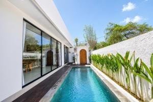 an indoor swimming pool in the backyard of a house at Santo Villa Uluwatu in Bingin Beach