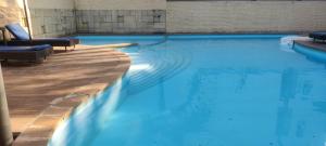 a swimming pool with blue water in a building at THE PALM's BED AND BREAKFAST IN ARPORA in Arpora