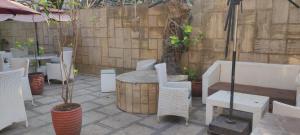 a patio with a table and chairs and a fence at THE PALM's BED AND BREAKFAST IN ARPORA in Arpora