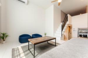 a living room with a table and blue chairs at iisa307 in Isahaya