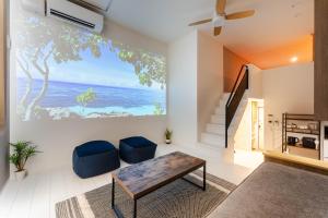 a living room with a table and a view of the ocean at iisa307 in Isahaya