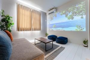 a living room with a table and a view of the ocean at iisa307 in Isahaya