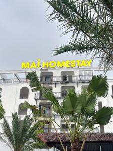 a building with a sign on the side of it at Mai Homestay in Ninh Binh