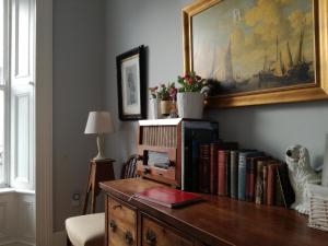 a room with a desk with books on it at The Merchants House in Kilrush