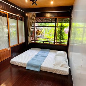 a large bed in a room with a window at Vũ Di Homestay in Hue