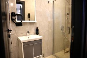 a bathroom with a sink and a shower at Aerohub Grand Hotel in Arnavutköy +40 photos