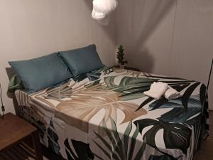 a bedroom with a bed with a tropical print at HINAMOE LODGE in Avatoru