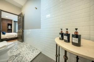 a bathroom with three bottles on a counter next to a toilet at Apirom Hometel in Sathani Lak Si +55 photos
