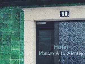 a building with a door with a sign on it at Mansao Alto Alentejo in Portalegre